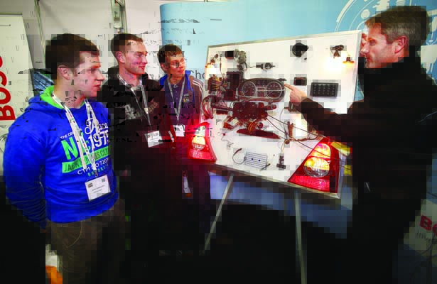 Mark Walsh Bosch Technical Trainer with MKW Motors chats with from left, apprentice mechanic Colin Fitzsimons and mechanics Stephen Forde and Jason Cave pictured at the Auto Trade Expo at CityWest on the Origo stand. 8th November 2014.